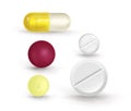 A set of multi-colored tablets of different shapes on a white background. Can be used for medical sites. Beautiful realistic vecto