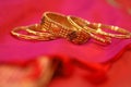 A set of gold kundan bangles on red silk saree Royalty Free Stock Photo