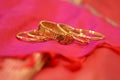 A set of gold kundan bangles on red silk saree Royalty Free Stock Photo