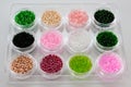 Set of multicolored beads for embroidery and needlework in plastic jars Royalty Free Stock Photo