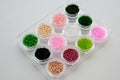 Set of multicolored beads for embroidery and needlework in plastic jars Royalty Free Stock Photo
