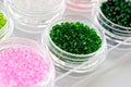 Set of multicolored beads for embroidery and needlework in plastic jars Royalty Free Stock Photo