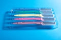 Set of multicolored female razors in a plastic box. On a blue background Royalty Free Stock Photo