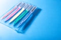 Set of multicolored female razors in a plastic box. On a blue background Royalty Free Stock Photo