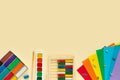 Set of multicolored paints, brushes, plasticine, paper, abacus, buttons and paper clips on  beige background.  School and office Royalty Free Stock Photo