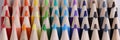 Set of multicolored pencils lying on white table in row Royalty Free Stock Photo