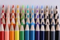 Set of multicolored pencils lying on white table in row Royalty Free Stock Photo