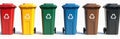 Set of multicolored plastic trash cans with recycling symbols stand in row. Different colored bins for waste sorting are on clean Royalty Free Stock Photo