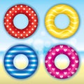 Set of multicolored swimming circles on a background of a blurry ocean and sky. Glare. Vector illustration for a postcard or a pos