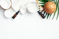 Set of natural coconut cosmetic on white background. Flat lay composition with coconut oil, hand cream, coconut half, grated