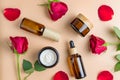 Set of natural organic SPA beauty products on beige background with red roses and petals. Homemade rose face oil Royalty Free Stock Photo
