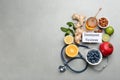 Set of natural products, stethoscope and card with text Immune System on grey table, flat lay