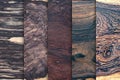 Set of natural real black white ebony wood planks with groove joints have a vertical background Royalty Free Stock Photo