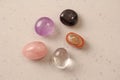 A set of natural stones lies on a light white background  garnet  amethyst  carnelian  rock crystal and rose quartz. Collection of Royalty Free Stock Photo