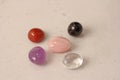 A set of natural stones lies on a light white background  garnet  amethyst  carnelian  rock crystal and rose quartz. Collection of Royalty Free Stock Photo