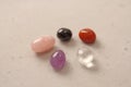 A set of natural stones lies on a light white background  garnet  amethyst  carnelian  rock crystal and rose quartz. Collection of Royalty Free Stock Photo