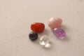 A set of natural stones lies on a light white background  garnet  amethyst  carnelian  rock crystal and rose quartz. Collection of Royalty Free Stock Photo