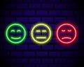 Set of neon smile emoticons isolated on dark brick wall background. Line icons. Happy and unhappy smileys. Emoji set. Colours Royalty Free Stock Photo