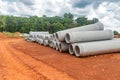 Set of new pipes stacked on yellow clay at a construction site Royalty Free Stock Photo