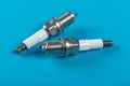 A set of new spark plugs a blue background Royalty Free Stock Photo