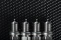 A set of new spark plugs of the car, and spare parts of vehicles on a dark background Royalty Free Stock Photo