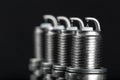 A set of new spark plugs of the car, and spare parts of vehicles on a dark background Royalty Free Stock Photo