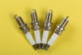 A set of new spark plugs a yellow background Royalty Free Stock Photo