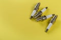 A set of new spark plugs a yellow background Royalty Free Stock Photo