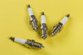 A set of new spark plugs a yellow background Royalty Free Stock Photo