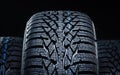 Winter tyres on black background with contrasty lighting Royalty Free Stock Photo