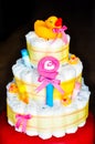 Set of newborn baby things - cake made from diapers on dark background Royalty Free Stock Photo