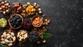 Set of nuts and dried fruits and berries on a black stone background. Top view. Royalty Free Stock Photo