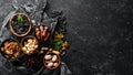 Set of nuts and dried fruits and berries on a black stone background. Top view. Royalty Free Stock Photo