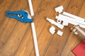 Set of objects and tools for assembling water pipes on a wooden floor background Royalty Free Stock Photo
