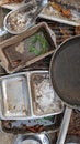 A set of old baking trays dishes and pans in a childs outdoor mud kitchen portrait Royalty Free Stock Photo