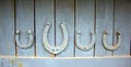 Set of old rusty horseshoes on a wooden background. Horseshoe is a symbol of good luck Royalty Free Stock Photo