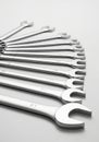 A set of open-end wrenches is neatly arranged in a fanned pattern on a smooth, light- Royalty Free Stock Photo