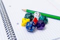 Set of open exercise book, pencil and dices Royalty Free Stock Photo