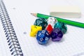 Set of open exercise book, pencil, rubber and dices on Royalty Free Stock Photo