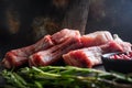 Set organic pork chop steaks over dark background wood and rustic steel, close up selective focus