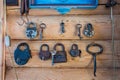 Set of padlocks and antique keys on wooden wall