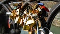 Set of padlocks tied to a slightly rusty metal parapet Royalty Free Stock Photo