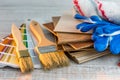 Set of paint brushes and roller on wooden desk Royalty Free Stock Photo