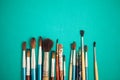Set of paint brushes on the turquois background