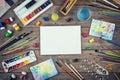 Set of painter accessories. Watercolor aquarelle paints, art brushes, palette, glass of water on old wooden background. Royalty Free Stock Photo