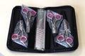 a set of 4 pairs of scissors and a comb for grooming dogs and cats