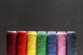Set of pastel colors thread for sewing on a black background. Set of threads on bobbins retro style. Vintage accessories for sewin Royalty Free Stock Photo