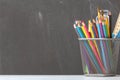 A set of pencils, brushes, paints is in the table against the background of the school board. The concept of education. Royalty Free Stock Photo