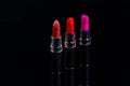 Set pf three lipsticks isolated on black background. Royalty Free Stock Photo