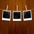 Set of photo frames on the rope with clothespin. Polaroid photo frames set on wooden background Royalty Free Stock Photo